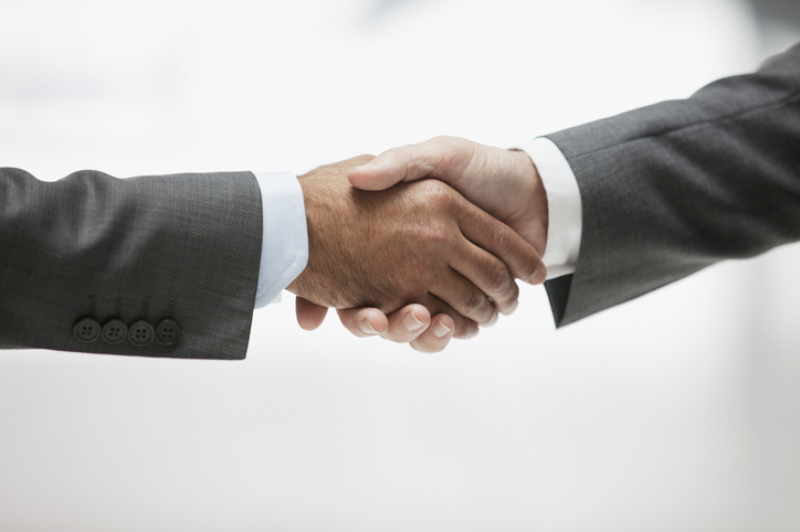 Two suited men shaking hands Two suited men shaking hands